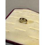 9ct gold ladies dress ring set with clear stones and garnets. weighs 2.25grams