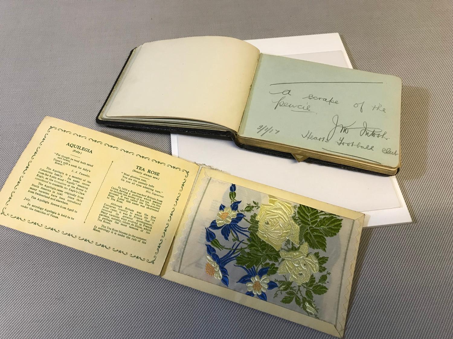 Old 1920's autograph book filled with various poem's, sayings and pictures together with silk flower