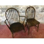 An Ercol Spindle back arm chair and single Ercol dining chair.