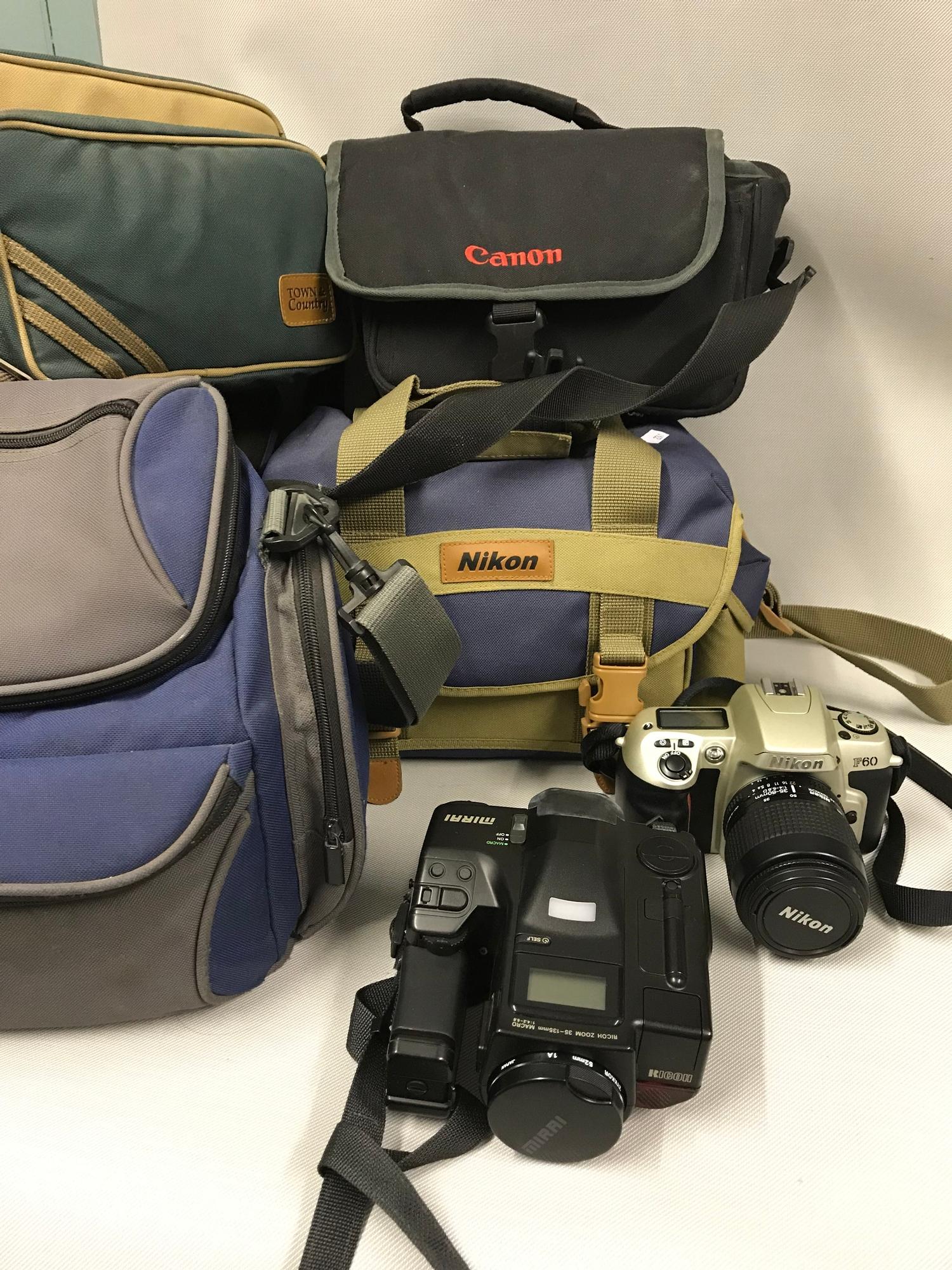 A lot of two cameras to include Nikon F60 camera & Ricoh, together with various camera bags