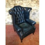 Blue chesterfield gullwing arm chair