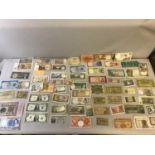 A Large collection of pre war and 1960's, 70's bank notes. Includes 1935 one dollar note, 1900