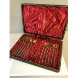 Birmingham silver 12 piece tea spoon set with matching sugar tongs fitted within a red silk interior