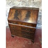 Flame Mahogany wood writing bureau with bow front drawer section and fitted interior.