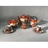 A lot of oriental porcelain tea wares, in a burnt orange tone and in three different designs