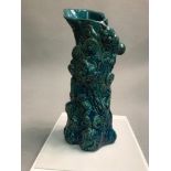 A Japanese turquoise blue glazed Oni vase, Decorated relief with Oni & Mons. 26cm in height.