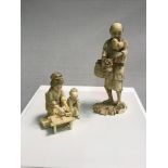 A Japanese Okimono of father figure with bird together with Japanese mother and child figures