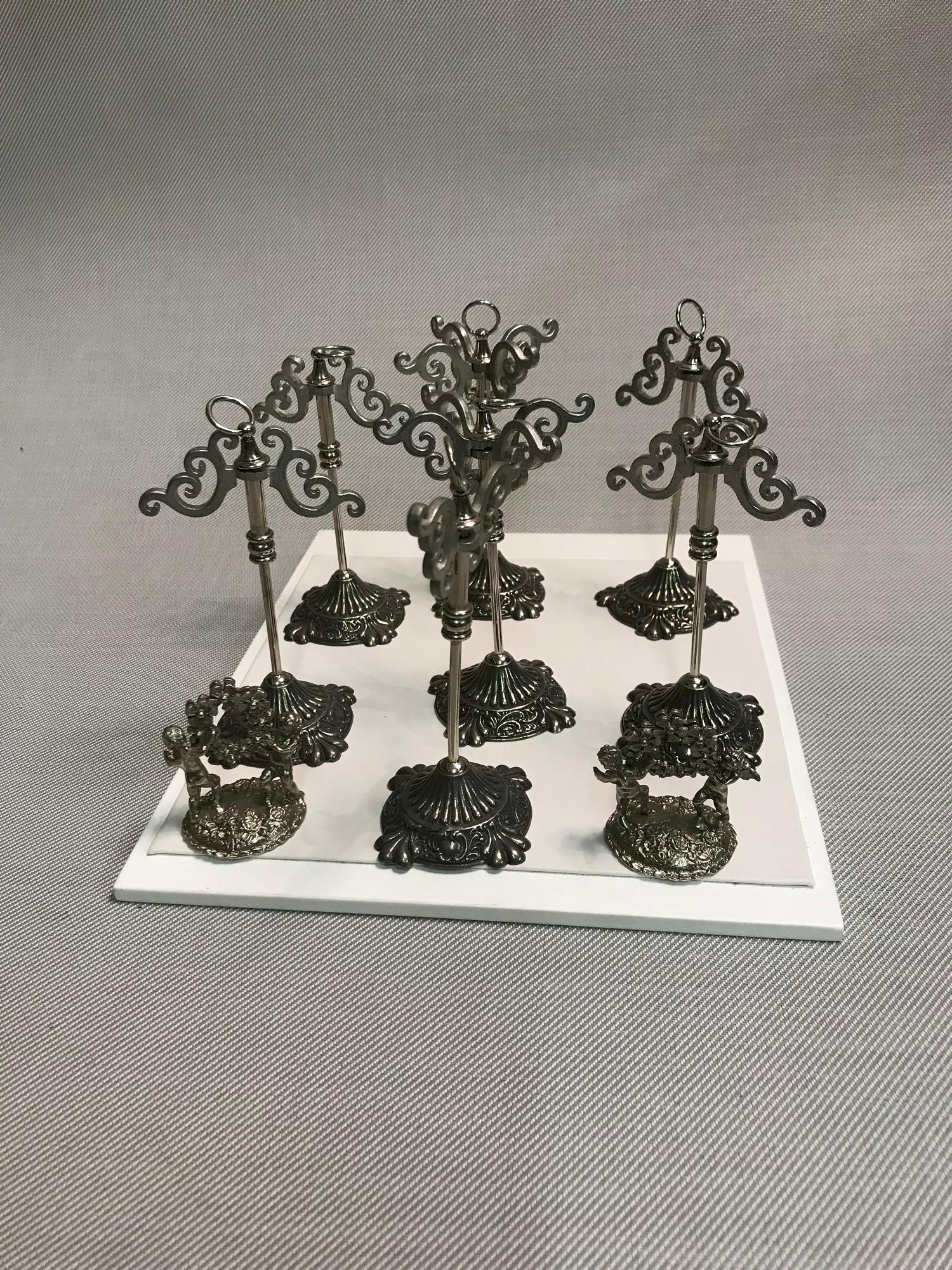 A Lot of silver plated jewellery stands together with 2 cherub and foliage design menu/ card holders