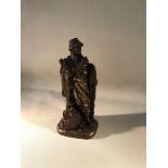 A bronze effect fisherman figurine, 22cm in height