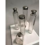 A Collection of various sized silver topped perfume and vessel pots. Tallest Measures 18cm in height