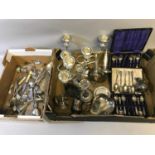 A large box filled with various EP items to include cutlery, candle sticks & serving dishes