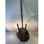 A tribal handmade string instrument, hide and wood material with shell detail