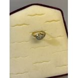 18CT Gold ladies ring set with a cluster of diamonds. Weighs 3.57grams