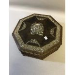 An octagonal musical jewellery box, rose design mounts to the surface (possible silver), basket