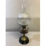 Art Nouveau brass and glass paraffin lamp with ornate globe shade