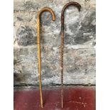 Two vintage cane walking sticks, one with a silver collar