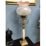 A Victorian corinthian column paraffin lamp. Made from glass, onyx & brass.