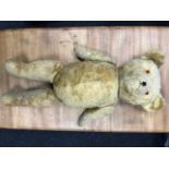 Large straw filled 1920s 30s teddy bear. Measures 63cm in height.