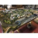 A large train set (8x4ft), with features such as a train station, village and industrial area.