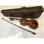 An antique violin with bow and leather travel case.
