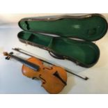 An antique childs violin, together with bow (named however unreadable)