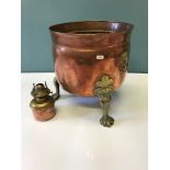 Large arts and crafts copper and brass three foot planter. Styled with lion head handles, ornate