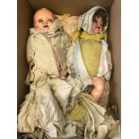 An early 1900's porcelain head doll and one other . Together with various clothes.