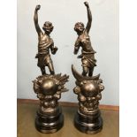 A pair of Spelter figurines on wooden plinths