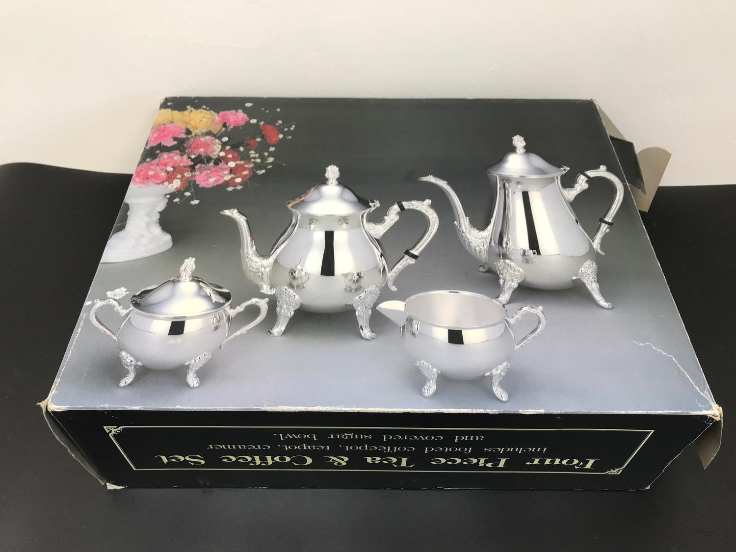 A Four piece tea & coffee set with original box.