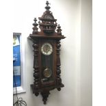 An Antique mahogany wall clock, Styled with an enamel and art nouveau brass face. Running condition.