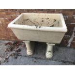 A large Victorian ceramic sink and pedestals