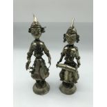 A Pair of Far Eastern white metal figurines. Both measure 18cm in height.