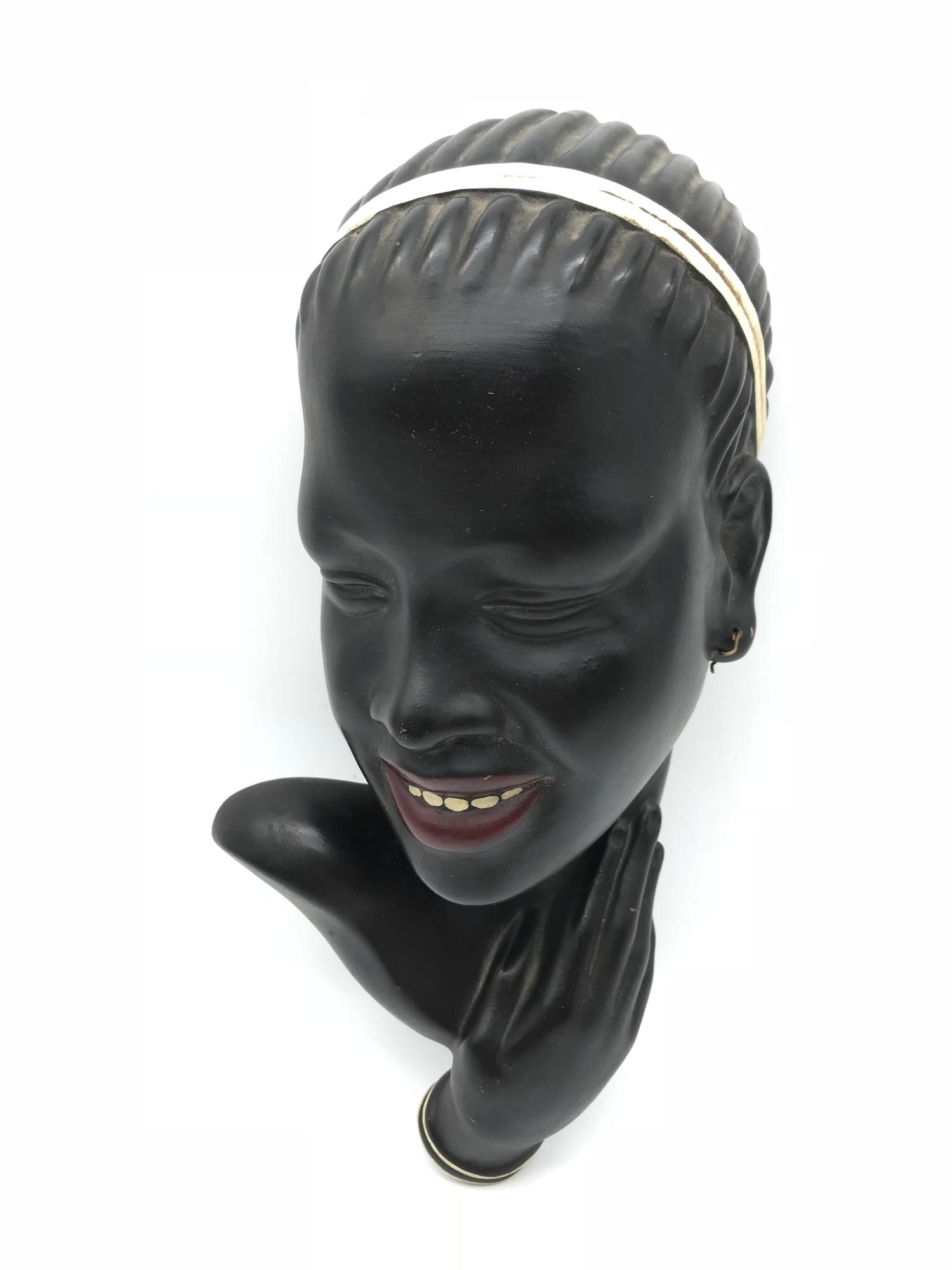 An Art Deco Austrian wall mask. By GK Fink. Measures 26cm in height.
