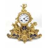 A Large Ormula French gilt metal mantle clock, Ornately designed with cherubs, Wreaths and birds.