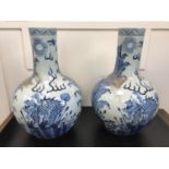2 Large Antique Blue and White oriental bottle neck vases, Designed with dragon faced foo dogs.