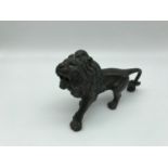 A Small Bronzed metal lion figure