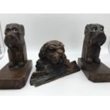 An antique black forest dog bust inkwell pot, together with two possible Black forest dog bookends