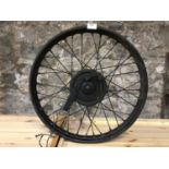 Vintage motorbike wheel, possible from a Triumph X model