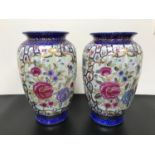 A Large pair of 20th century oriental hand painted vases. Measure 31cm in height.