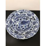 A Large oriental antique serving bowl. Designed with blue and white fish and swirls. Measures 40cm