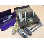 A vintage travel box filled with Birmingham silver handle manicure tools and silver nail buffers.