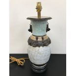 An antique Oriental table lamp designed with brown clay handles and dragon trims. Sat upon a hard