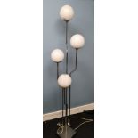 A 1970s retro floor standing lamp with 4 lamps , Has 3 white globe shades, 1 missing. Possibly