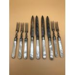 A Lot of fork and knives, styled with mother of pearl handles and Sheffield silver collars.