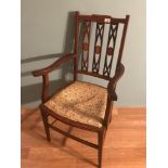 An Edwardian inlaid arm chair.