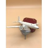 An Art Deco metal plane model sat upon a metal globe. Possibly a car mascot.