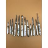 A lot of 12 Silver hall marked and mother of pearl fruit/ pen knifes. Includes Georgian silver and