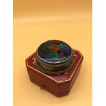 A Silver and enamel pill box.