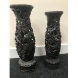 A Pair of antique Indonesian Highly carved pedestal stands. Tallest measures 40cm.