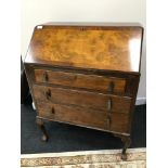 A 1950s 60s Writing bureau. Supported on Ball and claw feet. Comes with key.